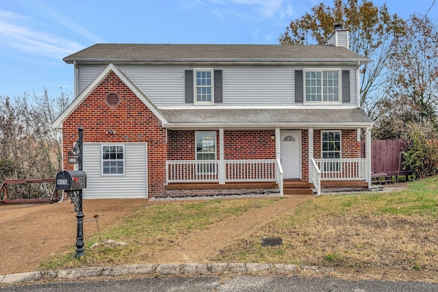 front facade with a front lawn and a porch