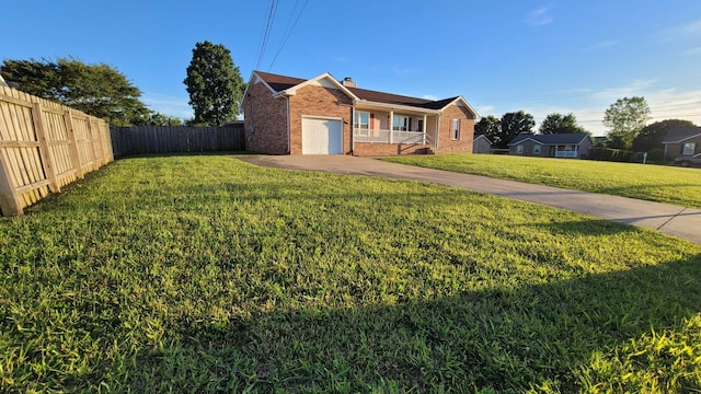 view of front facade with a front lawn, covered porch, and a garage