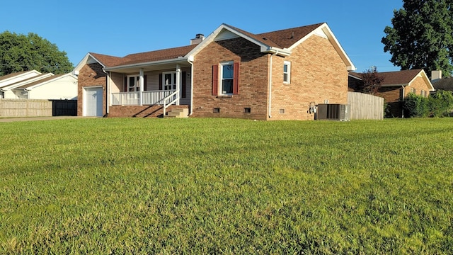 exterior space with a lawn, central AC, a porch, and a garage