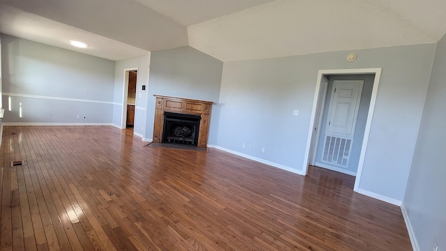 unfurnished living room with lofted ceiling and dark wood-type flooring