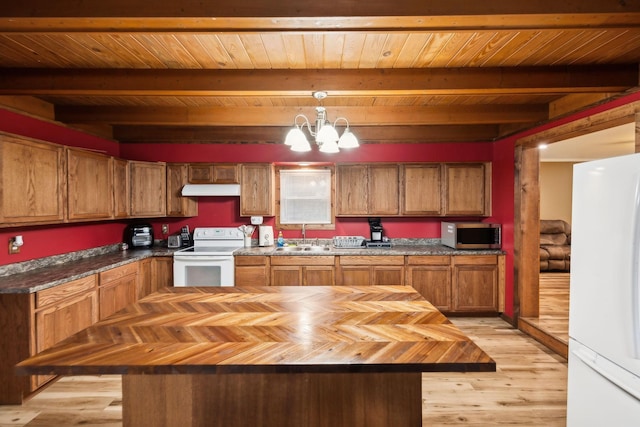 kitchen with white appliances, sink, a notable chandelier, beamed ceiling, and hanging light fixtures