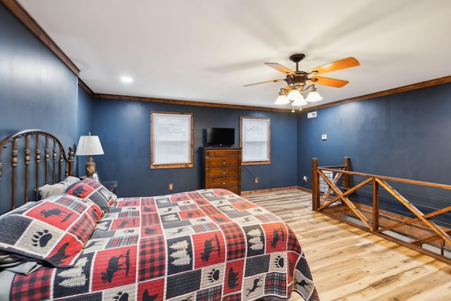 bedroom with ceiling fan, wood-type flooring, and ornamental molding