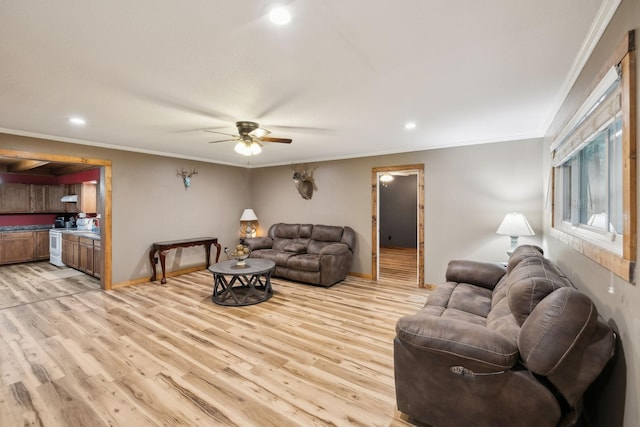 living room with light wood-type flooring, ceiling fan, and ornamental molding