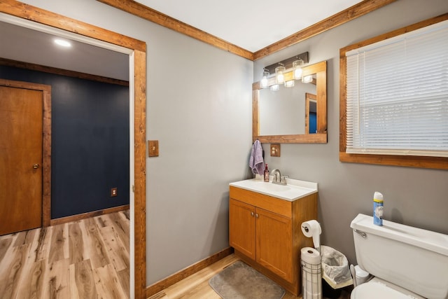 bathroom featuring wood-type flooring, vanity, and toilet