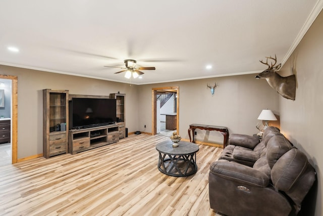 living room with ceiling fan, light wood-type flooring, and crown molding