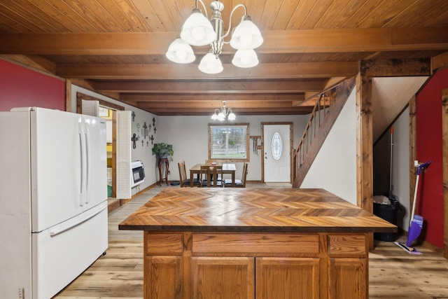 kitchen with a notable chandelier, decorative light fixtures, white fridge, and beamed ceiling