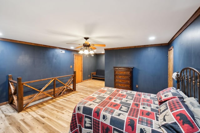 bedroom featuring hardwood / wood-style floors, ceiling fan, and crown molding