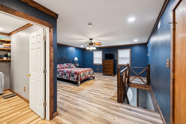 bedroom featuring crown molding, light hardwood / wood-style flooring, and ceiling fan