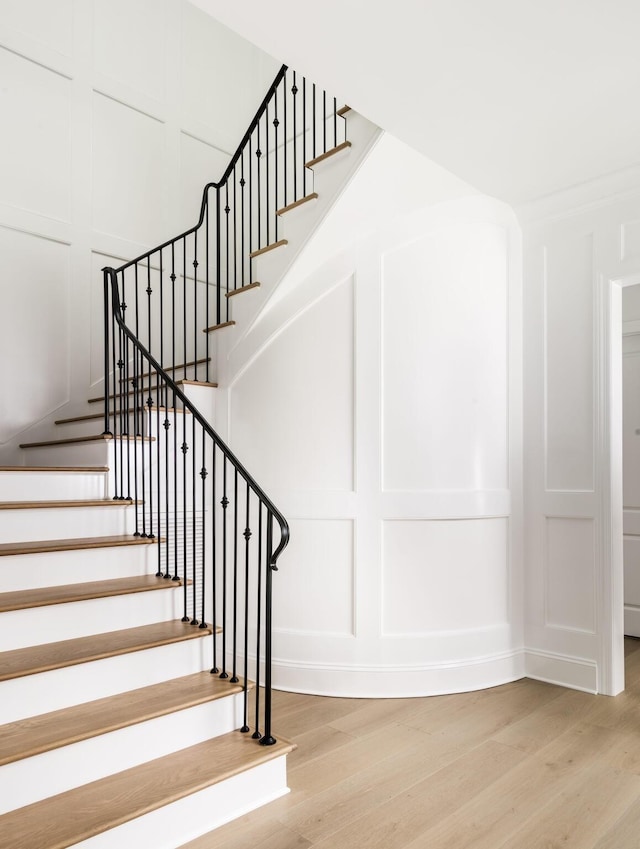 stairway with hardwood / wood-style flooring