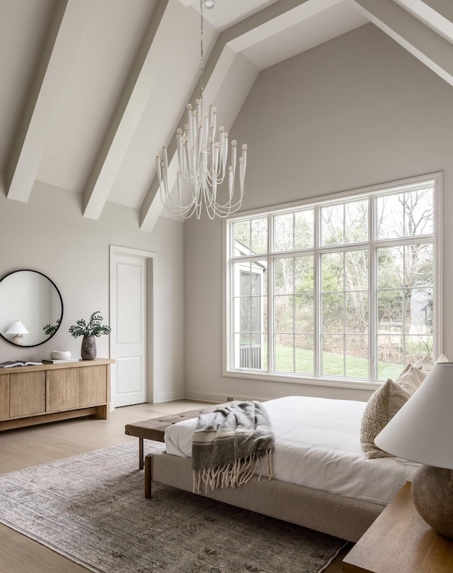 bedroom featuring lofted ceiling with beams, a chandelier, and wood-type flooring