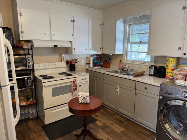 kitchen with white cabinetry, sink, white appliances, and washer / dryer