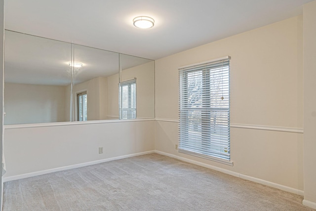 unfurnished room featuring baseboards and carpet floors