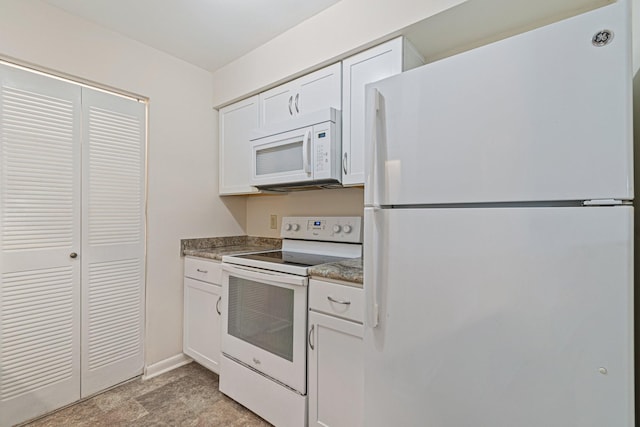 kitchen featuring white cabinets, white appliances, and baseboards