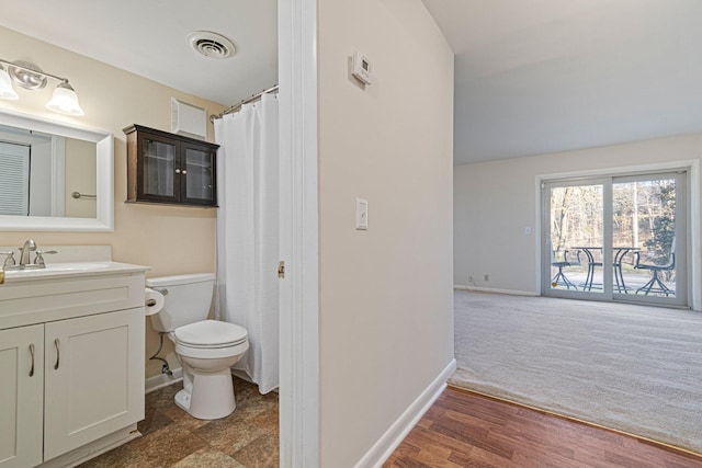 bathroom featuring visible vents, baseboards, toilet, and vanity