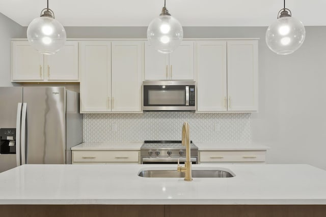 kitchen with pendant lighting, backsplash, and appliances with stainless steel finishes