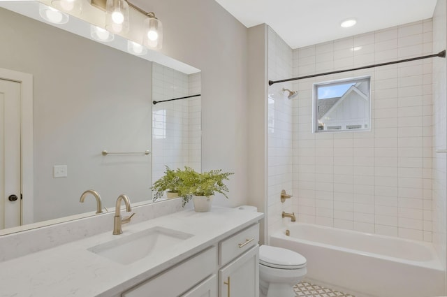 full bathroom featuring tiled shower / bath, vanity, toilet, and tile patterned flooring