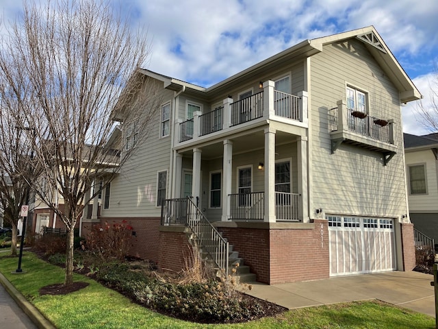 view of front of home with a garage and a balcony