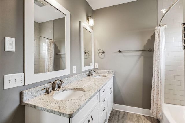 bathroom featuring shower / bath combination with curtain, vanity, and hardwood / wood-style flooring