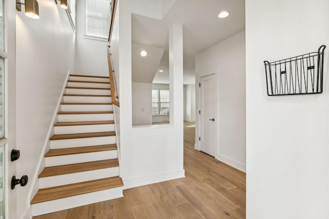 stairs with hardwood / wood-style floors