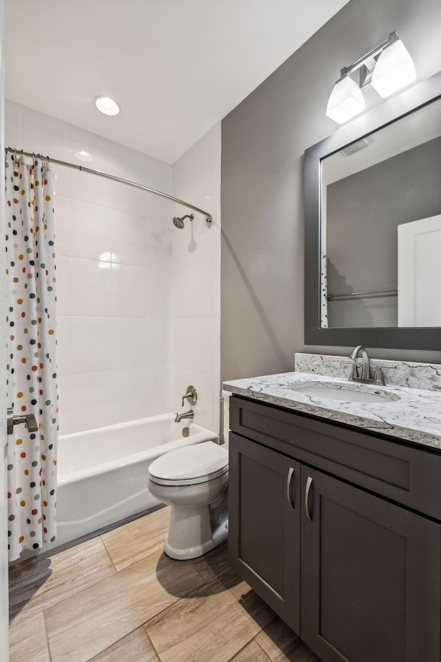 full bathroom with vanity, shower / bathtub combination with curtain, and toilet