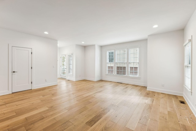 spare room featuring light hardwood / wood-style floors