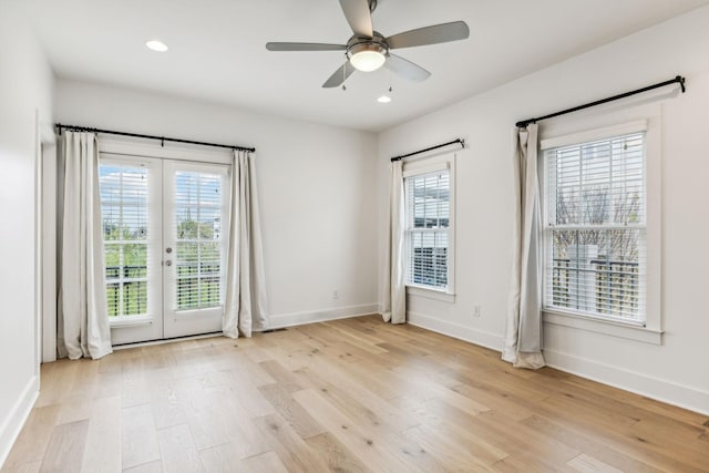 empty room with french doors, light hardwood / wood-style floors, and ceiling fan