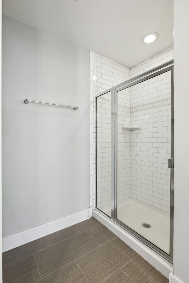 bathroom featuring a shower with door