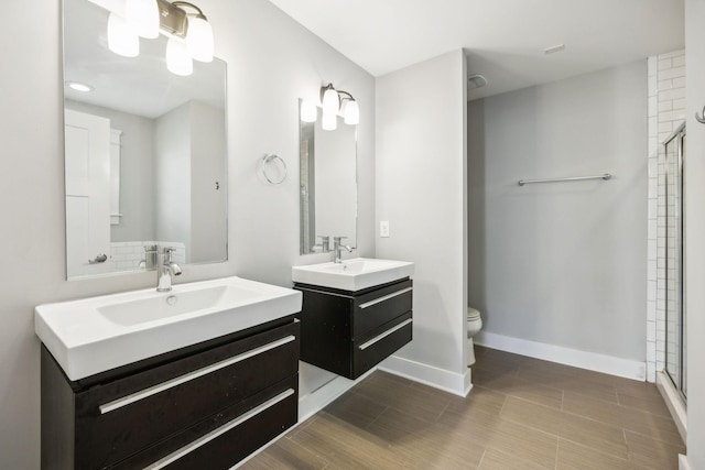 bathroom featuring walk in shower, vanity, and toilet