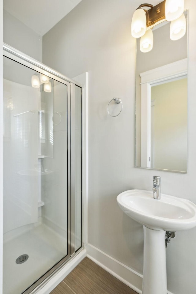 bathroom with wood-type flooring and walk in shower