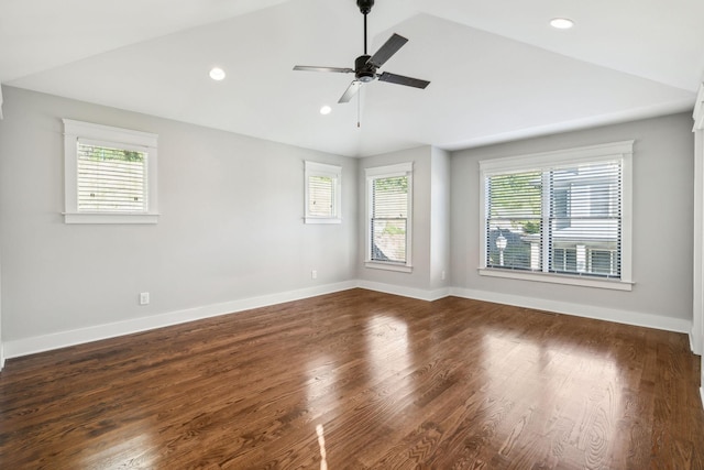 empty room with lofted ceiling, dark hardwood / wood-style flooring, and ceiling fan