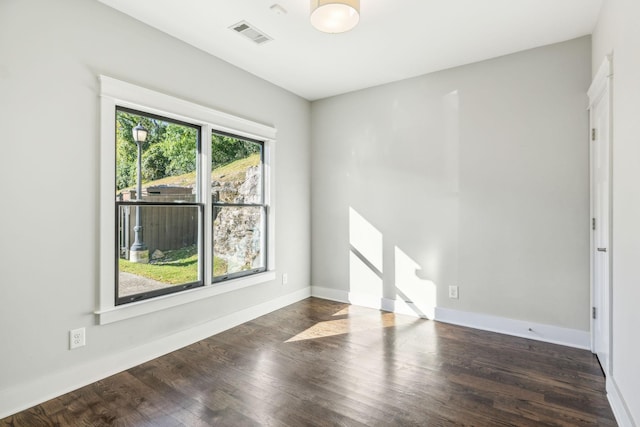 unfurnished room featuring dark wood-type flooring