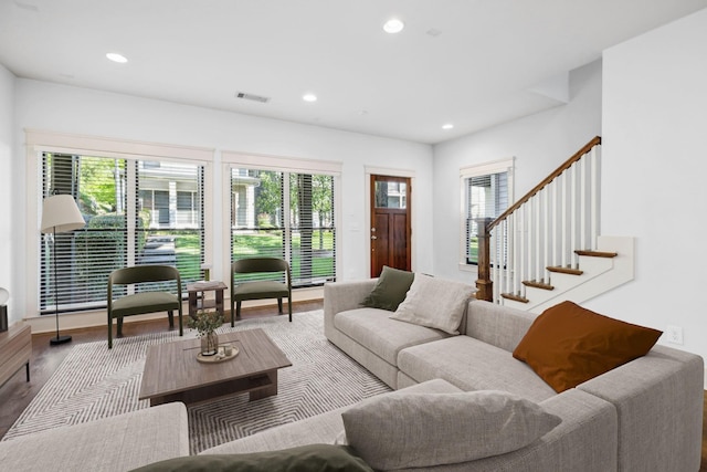 living room with hardwood / wood-style flooring and a healthy amount of sunlight