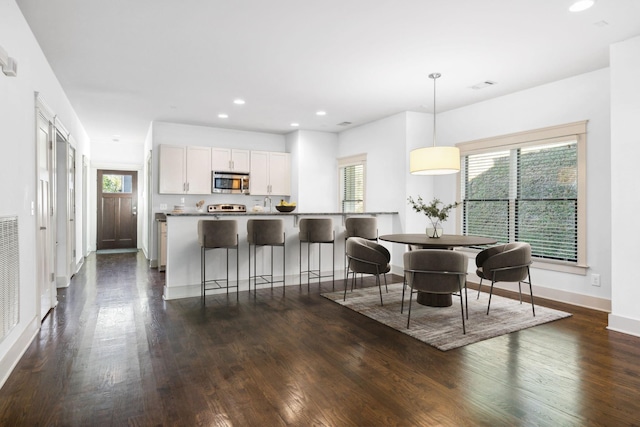 dining area featuring dark hardwood / wood-style flooring