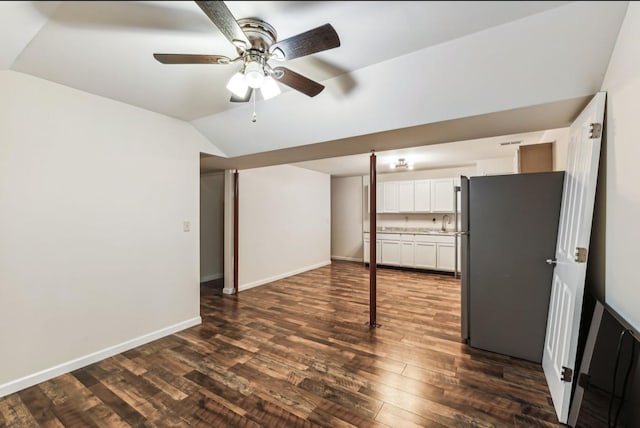 basement with stainless steel refrigerator, ceiling fan, dark hardwood / wood-style flooring, and sink