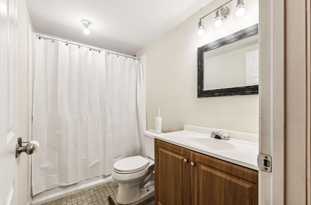 bathroom with tile patterned flooring, vanity, and toilet