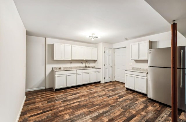 kitchen featuring white cabinets, stainless steel fridge, sink, and dark wood-type flooring