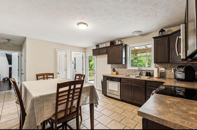 kitchen featuring dark brown cabinetry, a wealth of natural light, sink, and appliances with stainless steel finishes