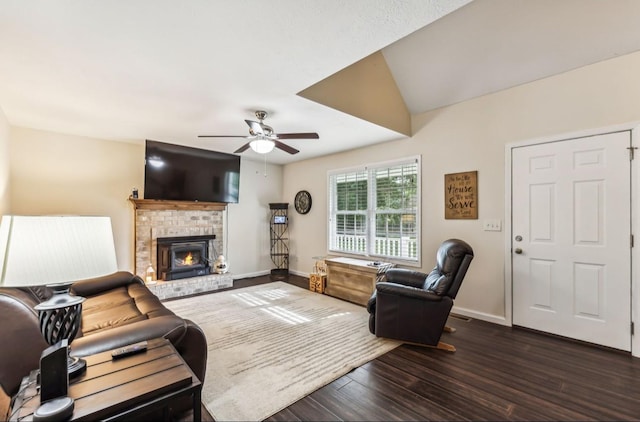 living room with ceiling fan, dark hardwood / wood-style flooring, and a fireplace