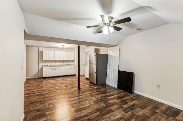 unfurnished living room featuring dark hardwood / wood-style flooring, ceiling fan, lofted ceiling, and sink