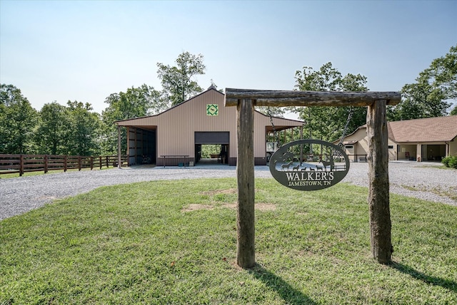 exterior space featuring an outdoor structure and a front lawn