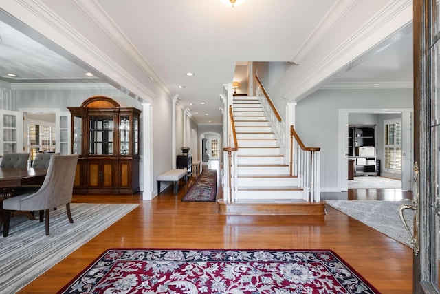 entrance foyer featuring wood-type flooring and crown molding