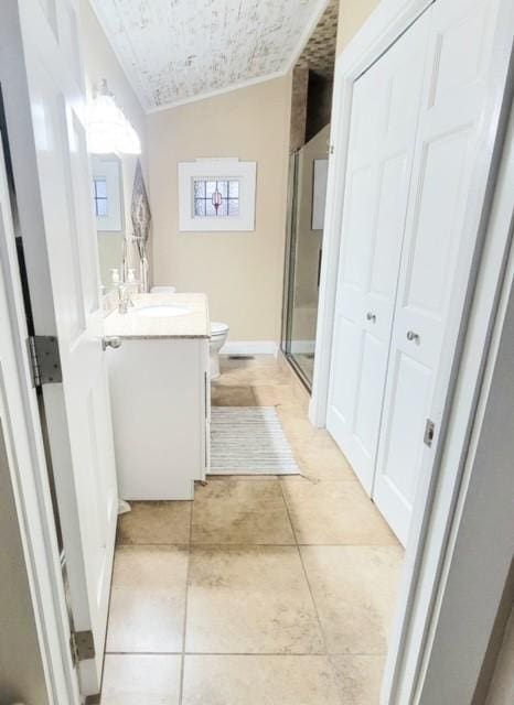 bathroom featuring walk in shower, vanity, tile patterned flooring, toilet, and lofted ceiling