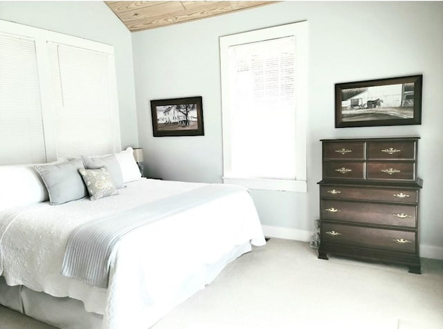 carpeted bedroom featuring wood ceiling and lofted ceiling