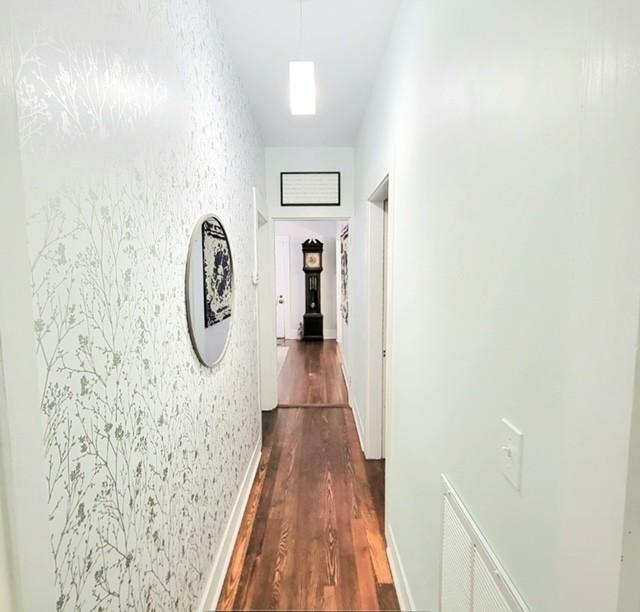 hallway with dark hardwood / wood-style flooring