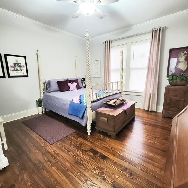 bedroom featuring ceiling fan, dark hardwood / wood-style flooring, and crown molding