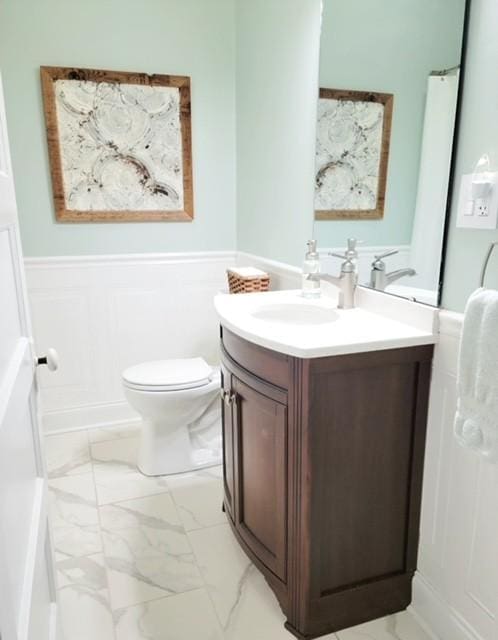 bathroom featuring vanity and toilet