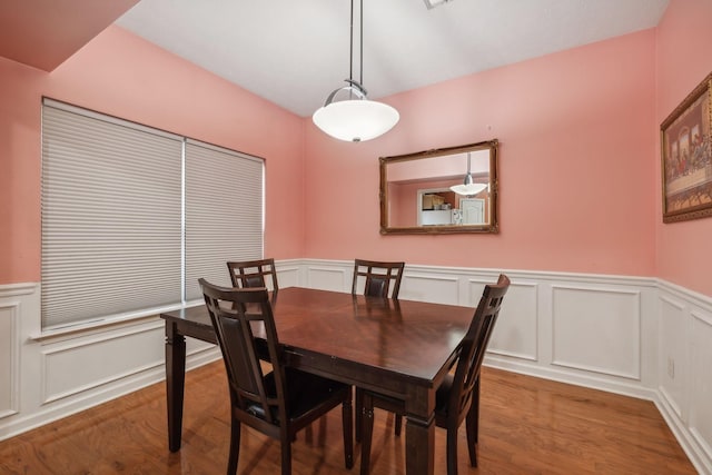 dining space with hardwood / wood-style flooring