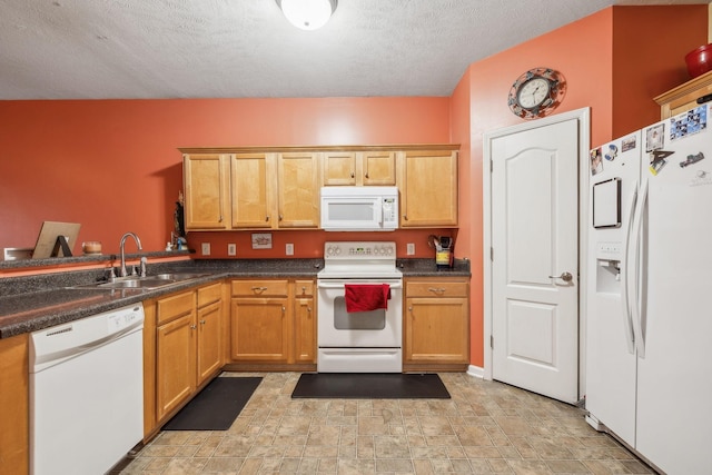 kitchen with a textured ceiling, kitchen peninsula, sink, and white appliances