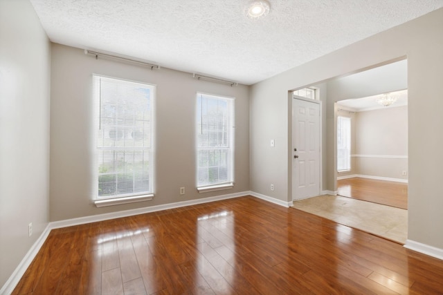 entryway featuring hardwood / wood-style floors, a textured ceiling, and a wealth of natural light