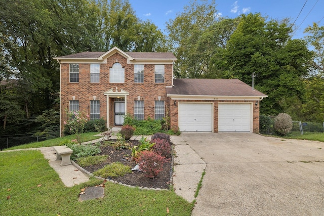 colonial house with a garage and a front lawn